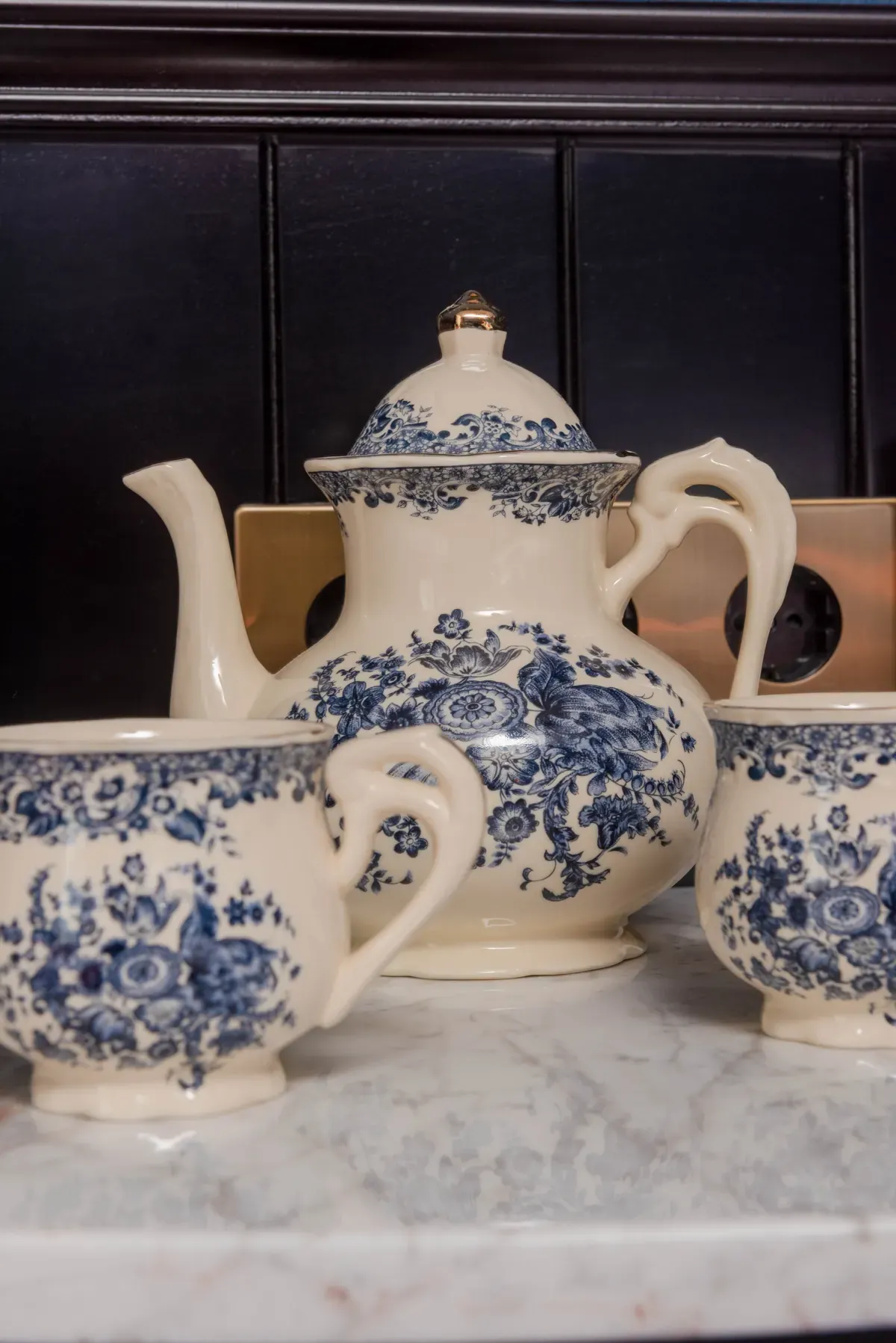 Porcelain tea set on the marble in the triple room