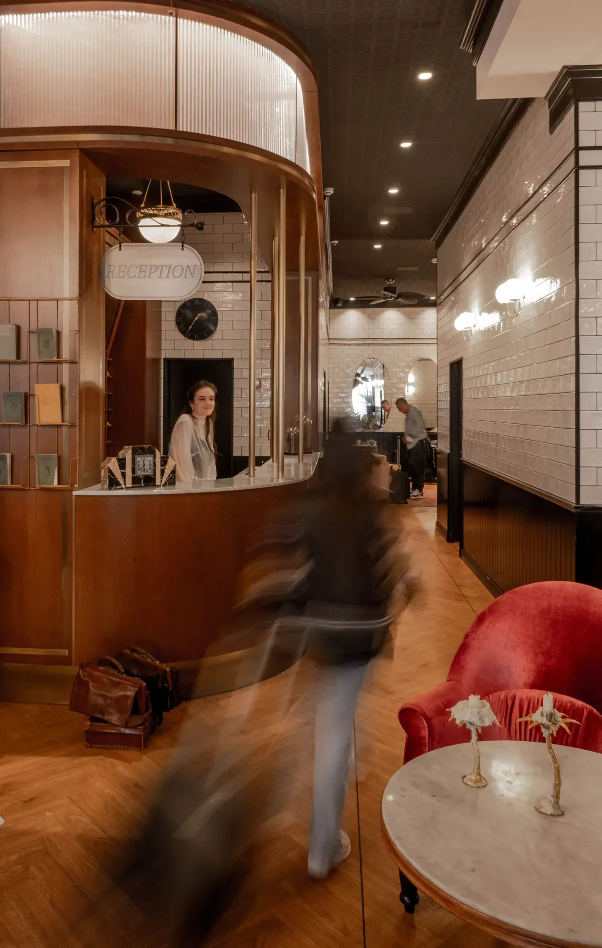 Craves Hotel reception, wooden desk and red armchair