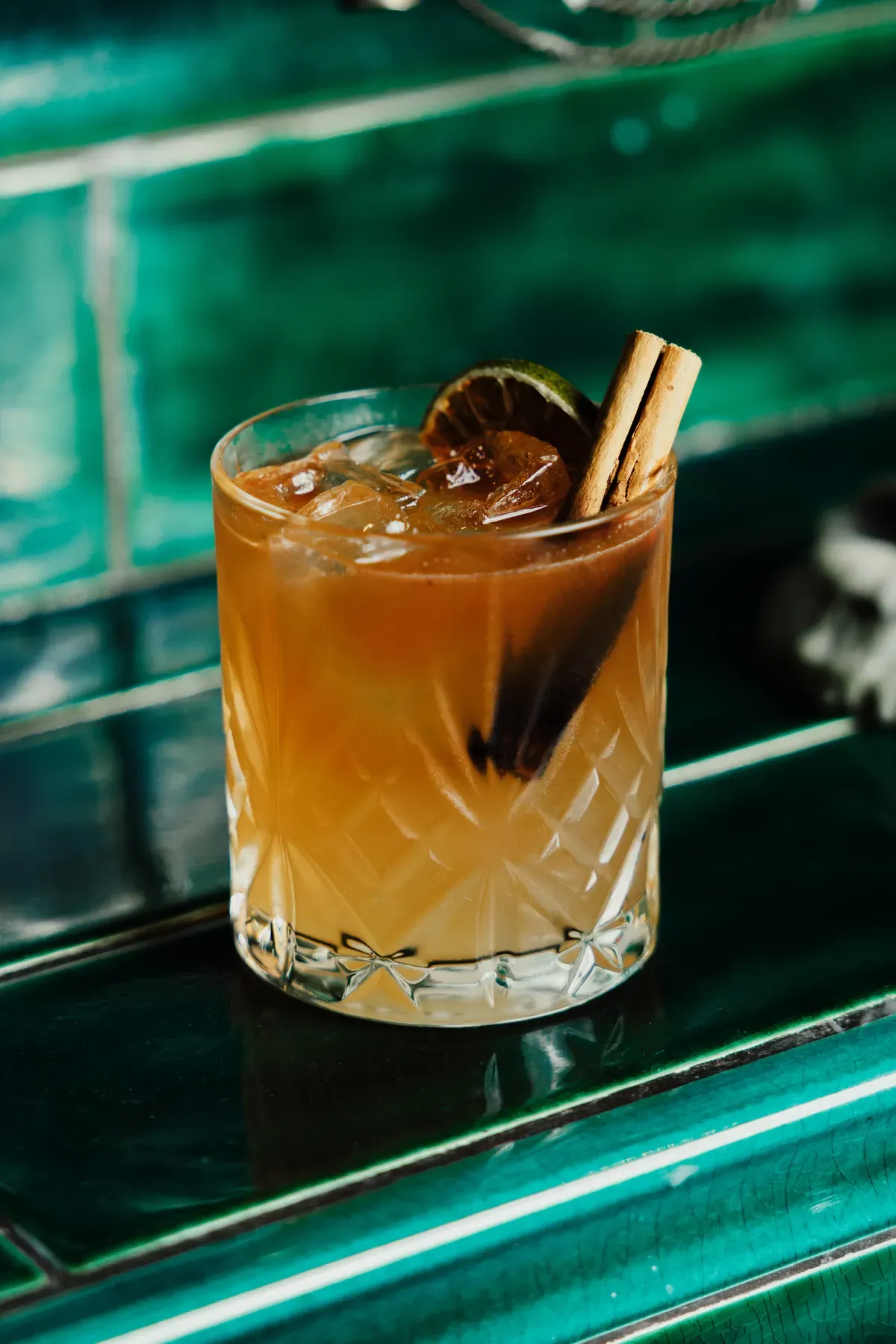 Amber cocktail with dried lemon and cinnamon