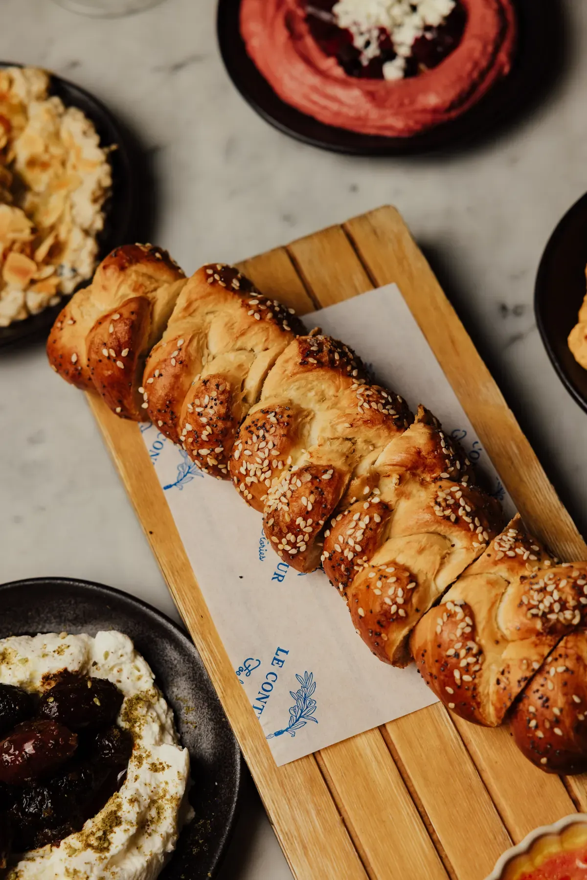 Braided sesame bread and mezze to share at Le Conteur