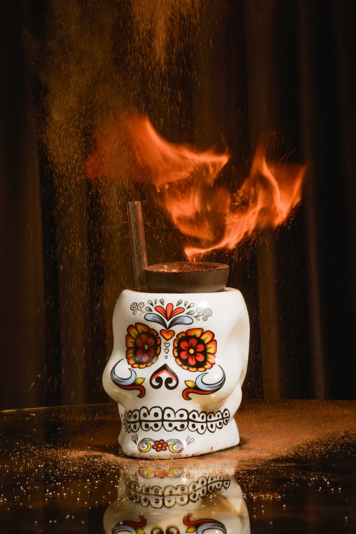 Flaming cocktail served in a colourful skull at the Scène bar