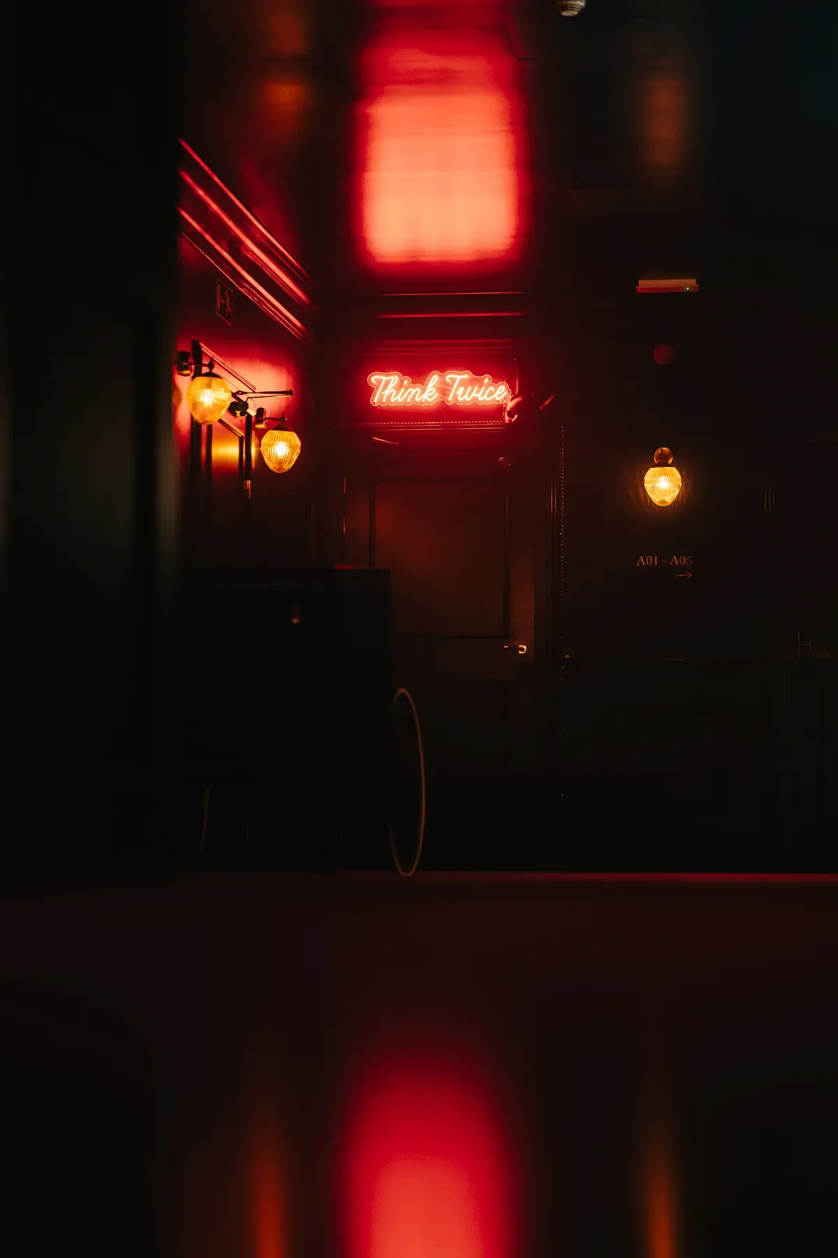 Red neon sign at the entrance to the Scène bar